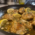 ['A close-up view of juicy zesty chicken breasts garnished with herbs and lemon zest.', 'Side angle of succulent chicken breasts, glistening with olive oil and herbs, ready to serve.', 'A vibrant presentation of grilled chicken, showcasing its tender texture and lemon garnish.', 'Detailed shot of flavorful chicken breasts marinated with lemon and spices against a rustic backdrop.']