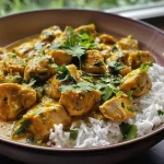 ['Close-up of a bowl of Moroccan Coconut Chicken Curry with colorful ingredients.', 'Side view of a vibrant Moroccan curry dish featuring chicken and coconut milk.', 'Juicy pieces of chicken in a creamy coconut sauce garnished with herbs.', 'A delicious Moroccan Coconut Chicken Curry displayed in a rustic bowl.']