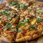 ['Close-up view of Sweet Chili Garlic Chicken Pizza topped with colorful ingredients.', 'Juicy Sweet Chili Garlic Chicken Pizza with vibrant toppings and melted cheese.', 'Side view of a pizza loaded with chicken, pineapple, and fresh vegetables.', 'Sweet Chili Garlic Chicken Pizza featuring a golden crust and garnishes.']