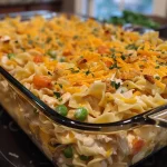 Close-up view of a creamy Chicken and Noodle Casserole topped with golden, crushed crackers.