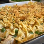 Close-up view of a creamy chicken casserole topped with crushed Ritz crackers.