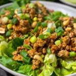 Close-up of healthy chicken lettuce wraps filled with ground chicken and vegetables.