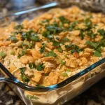 Close-up view of a creamy Ritz Cracker Chicken Casserole topped with crushed crackers.