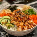 Close-up of a Chicken Sushi Bowl featuring sliced chicken, avocado, and colorful vegetables.